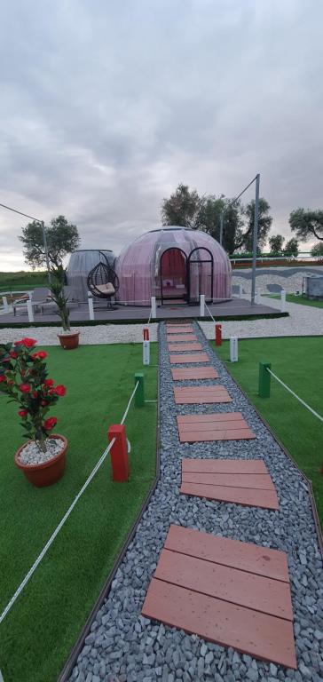 a row of stepping stones in front of a tent at Maremonti Glamping in Ancarano
