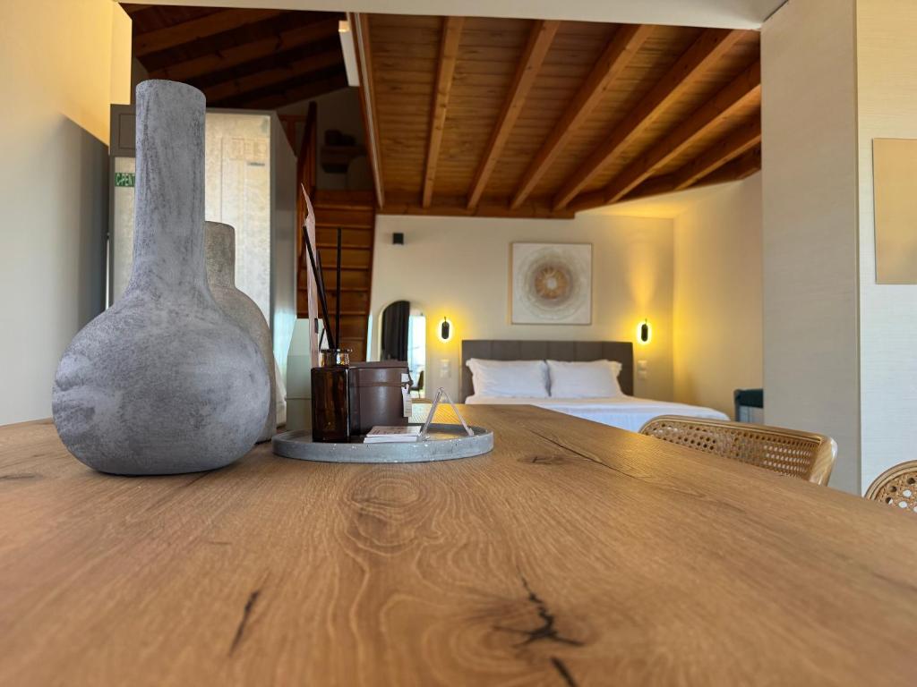 a large wooden table in a room with a bed at Mersea deluxe apartment Kourouta in Kourouta