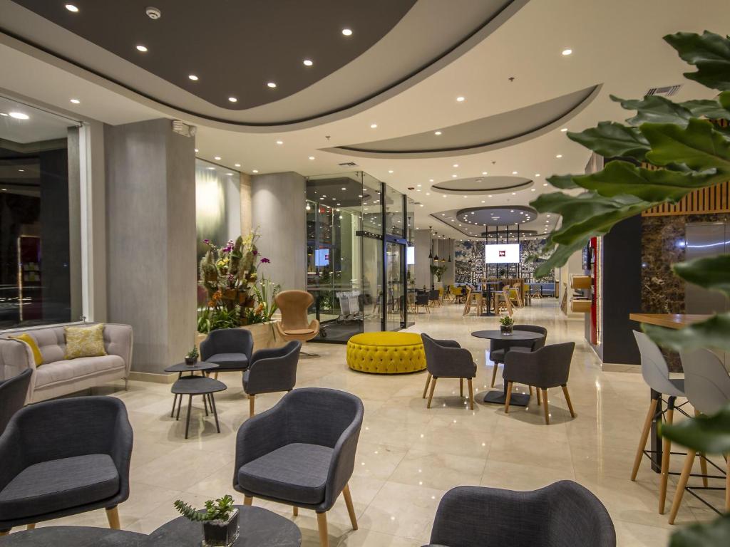 a lobby of a store with chairs and tables at ibis Quito in Quito