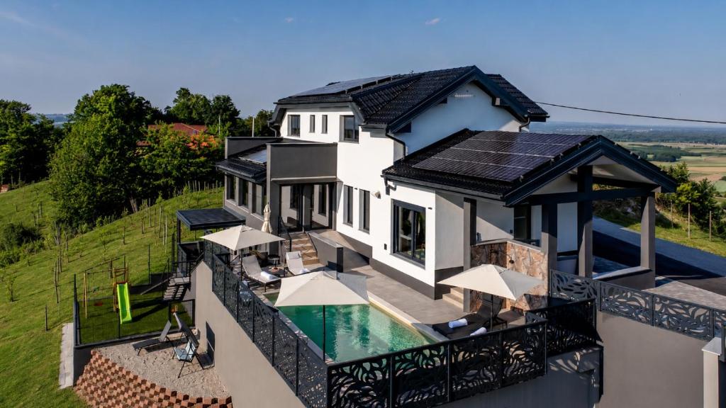 an aerial view of a house with solar panels on the roof at Northern Croatia Accessible Luxury Villa in Cestica