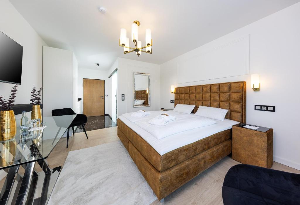 a bedroom with a large bed and a desk at Ferienwohnung 210 Salinenparc Design Budget Hotel in Erwitte