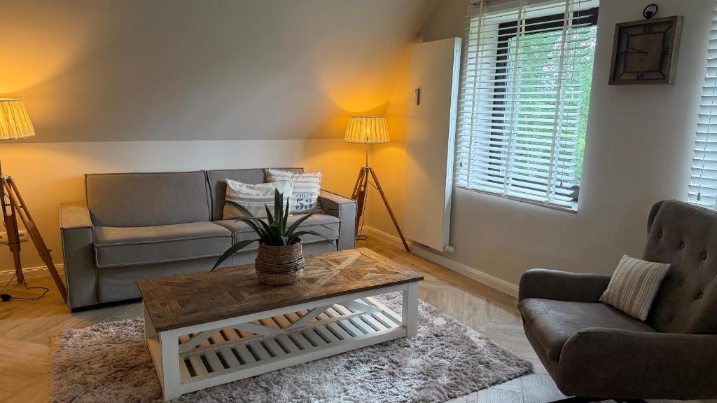 a living room with a couch and a table at Ferienwohnung De ole School mit eigener Sauna! in Fehmarn