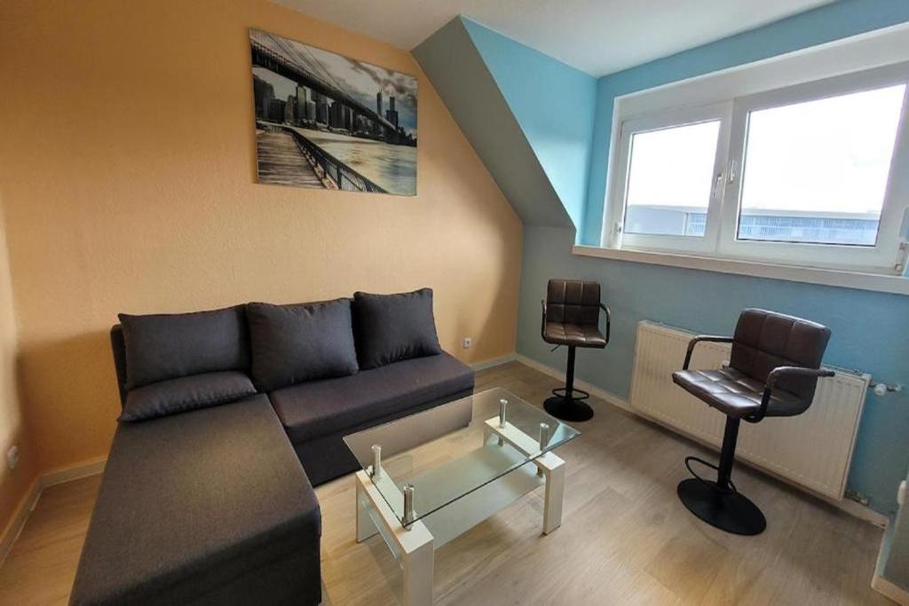a living room with a couch and two chairs at Privilege - Viel inklusiv! in Viersen