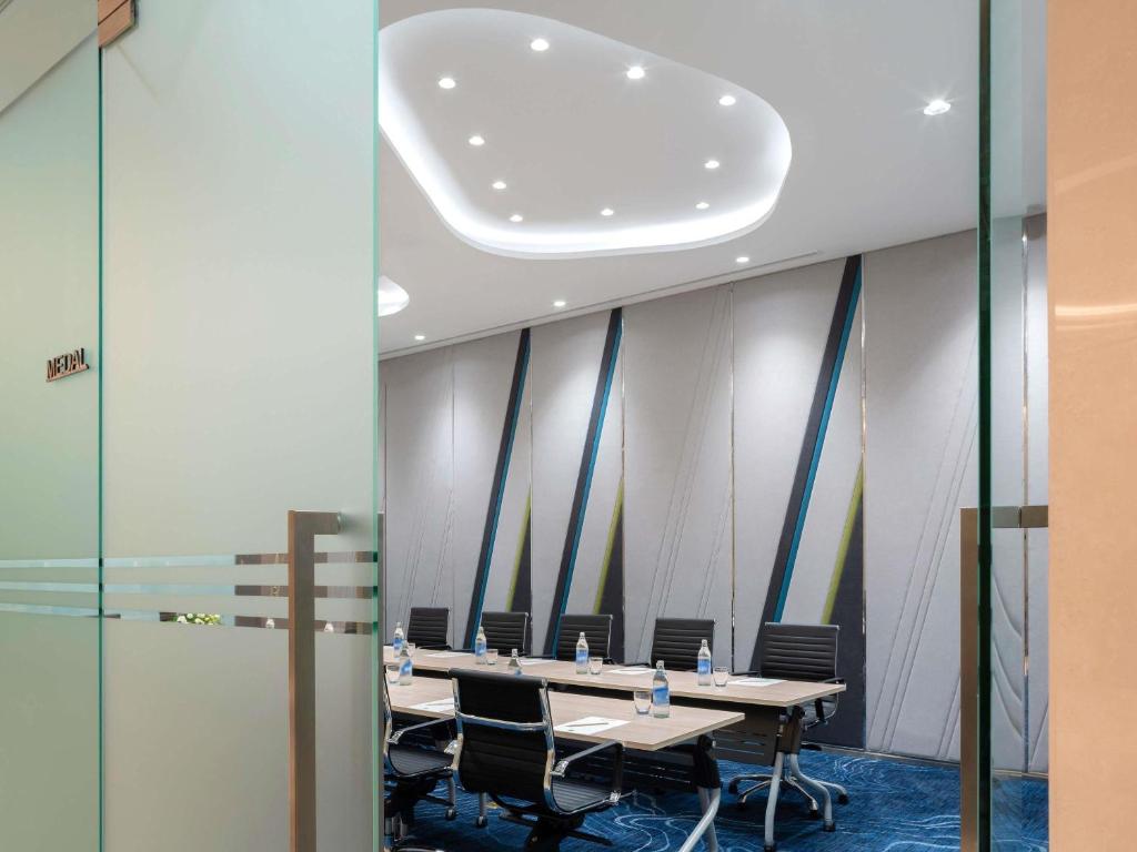 A conference room viewed through glass doors, set for a compact meeting.