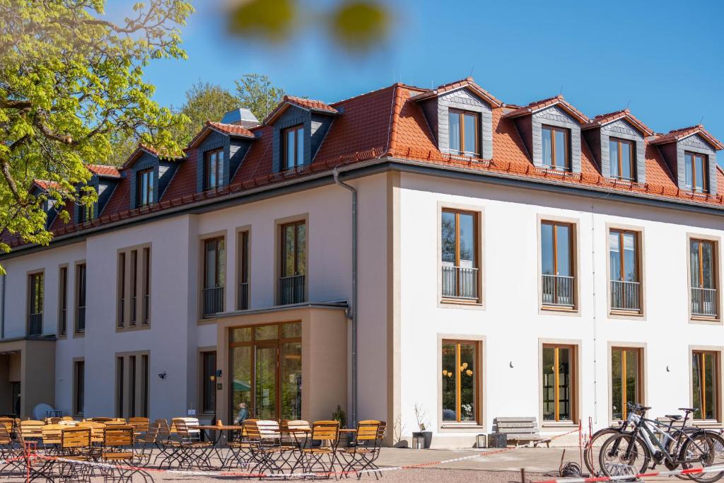 a large white building with a red roof at Waldhotel Hohe Sonne Eisenach in Eisenach