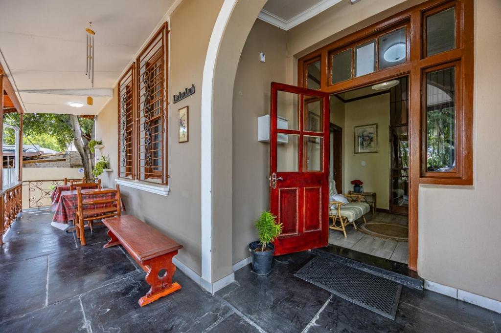 a red door on a house with a porch at The 196 City Lodge in Pretoria