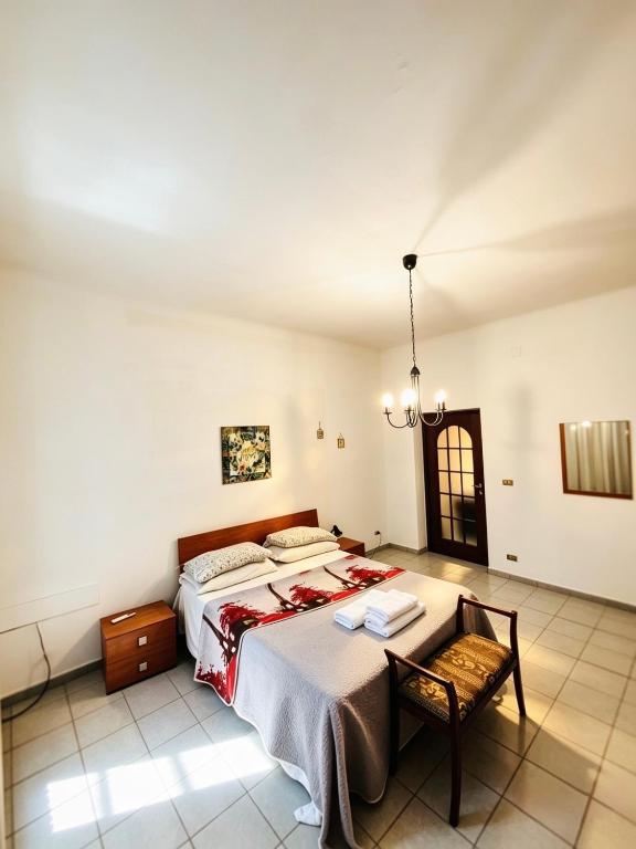 a bedroom with a bed and a table and a chair at Casa bea in Taranto