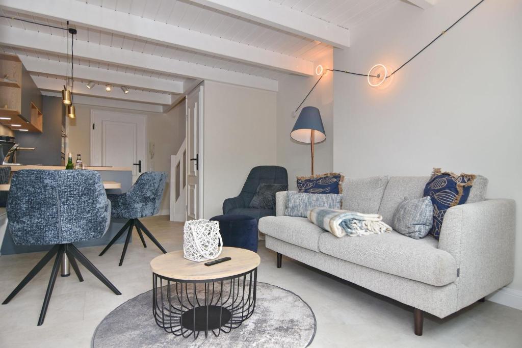 a living room with a couch and a table at Alma & Eva, Whg 5 in Westerland
