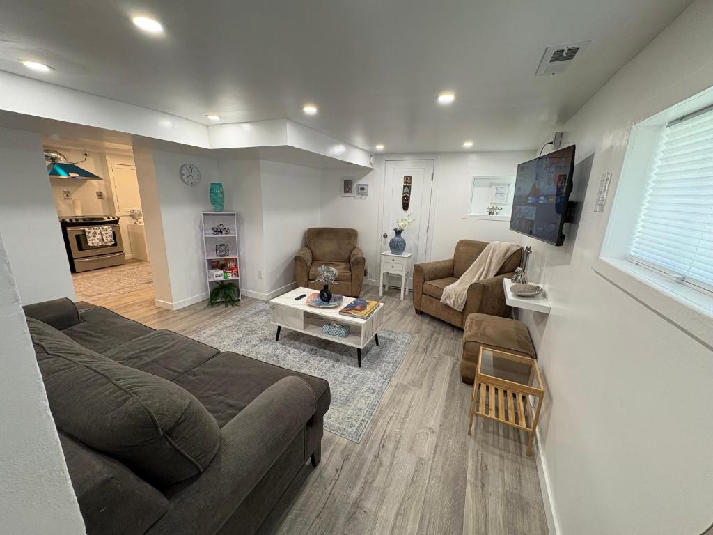 a living room with a couch and a table at Silverado Suite Modern Quiet 2BR Queen's Downtown in Kingston