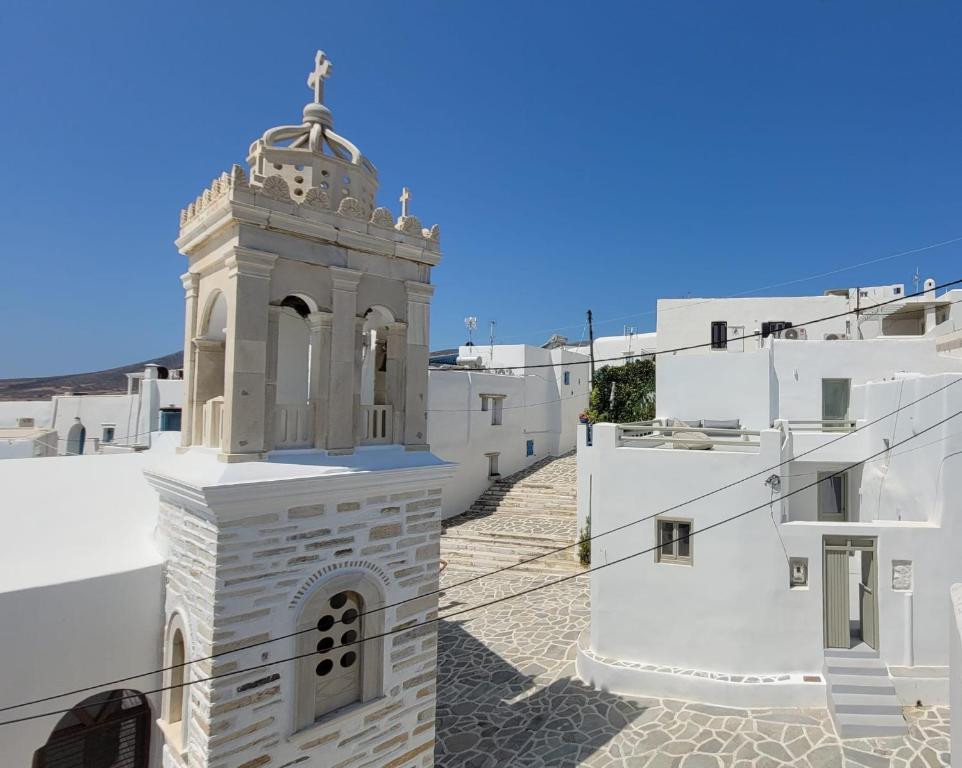 a clock tower on the side of a building at Marpissa - Traditional House in Márpissa