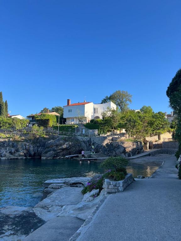 a body of water with buildings in the background at Holiday Home Valica in Malinska