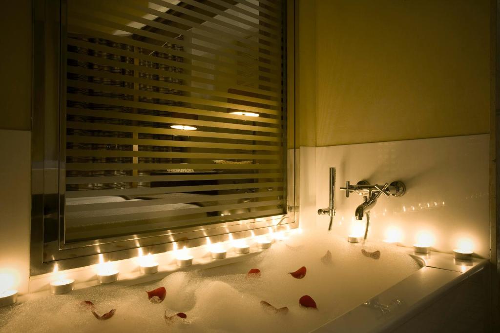 a bathroom with a window with hearts on the floor at Villa Oniria in Granada