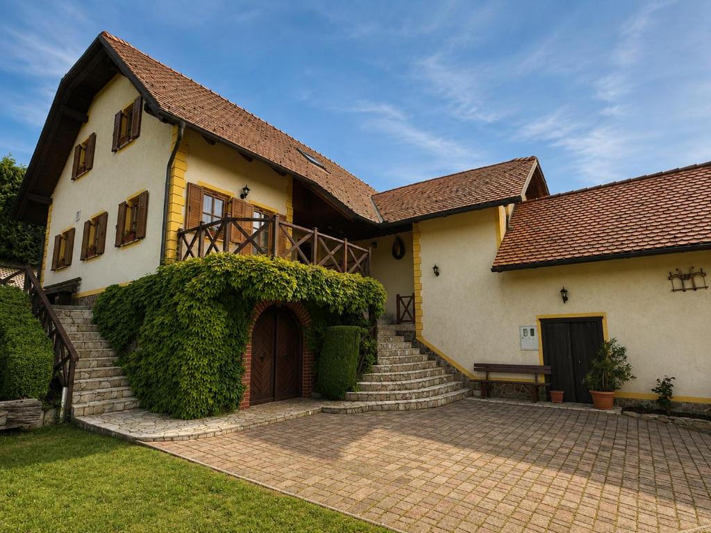 a house with a brick walkway in front of it at Zidanica Jakec Wine House & Scenic Views in Podlehnik