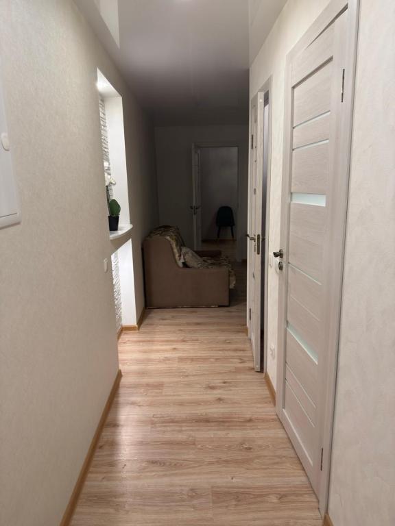 a hallway leading to a living room with a door at Urban Place by Kelvin in Narva