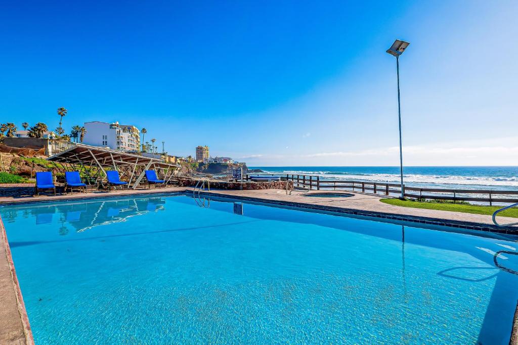 a swimming pool with the beach in the background at Dog-friendly Villa with Heated Pool, Hot Tub, Streaming, Partial Ocean Views in Rosarito