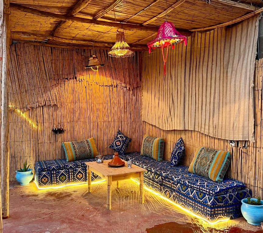 a living room with a blue couch and a table at Surf Apartment in Tamri Rooftop Local Experience in Tamri