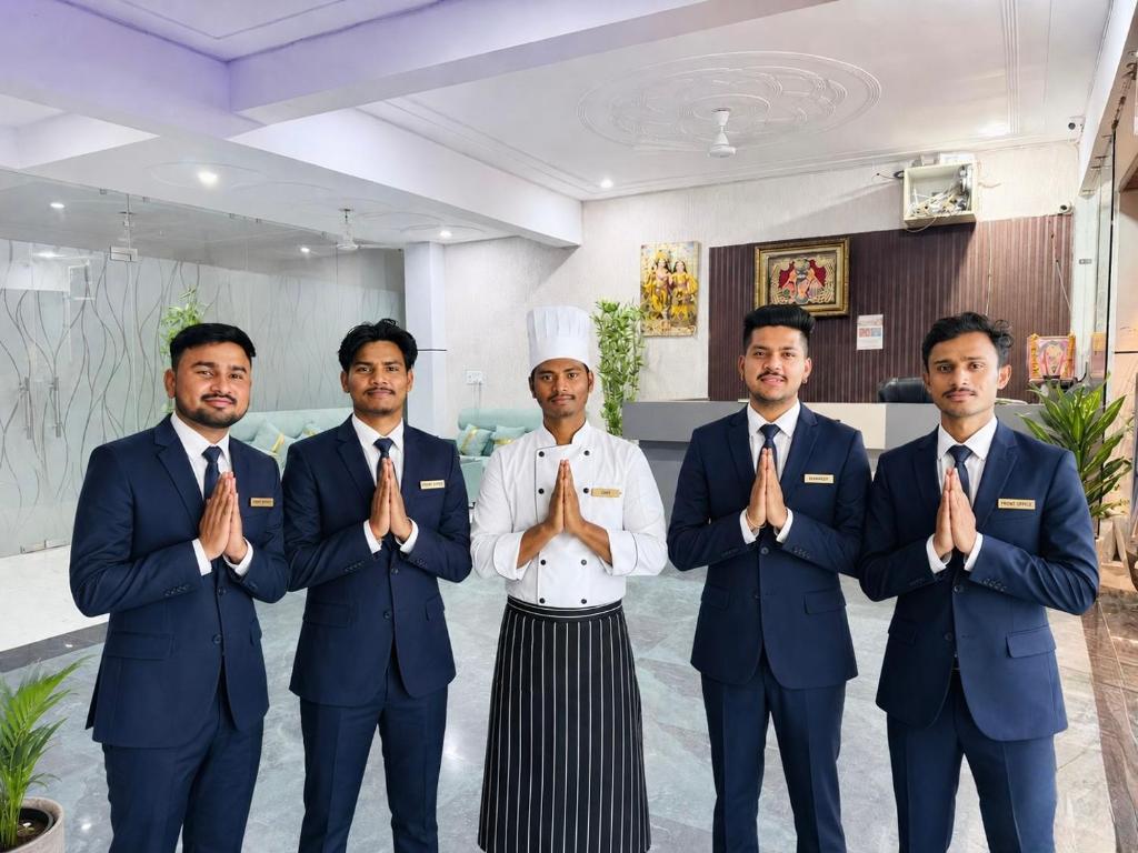 a group of men in suits and a chef at Shri Prem Sharnam - By The Aureo Hotels in Vrindāvan