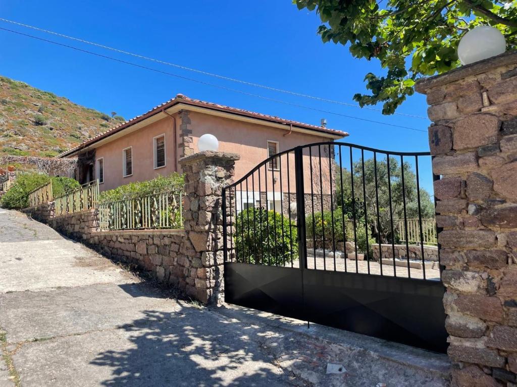 a gate in front of a house at Villa Rosmarino sea view in Capraia
