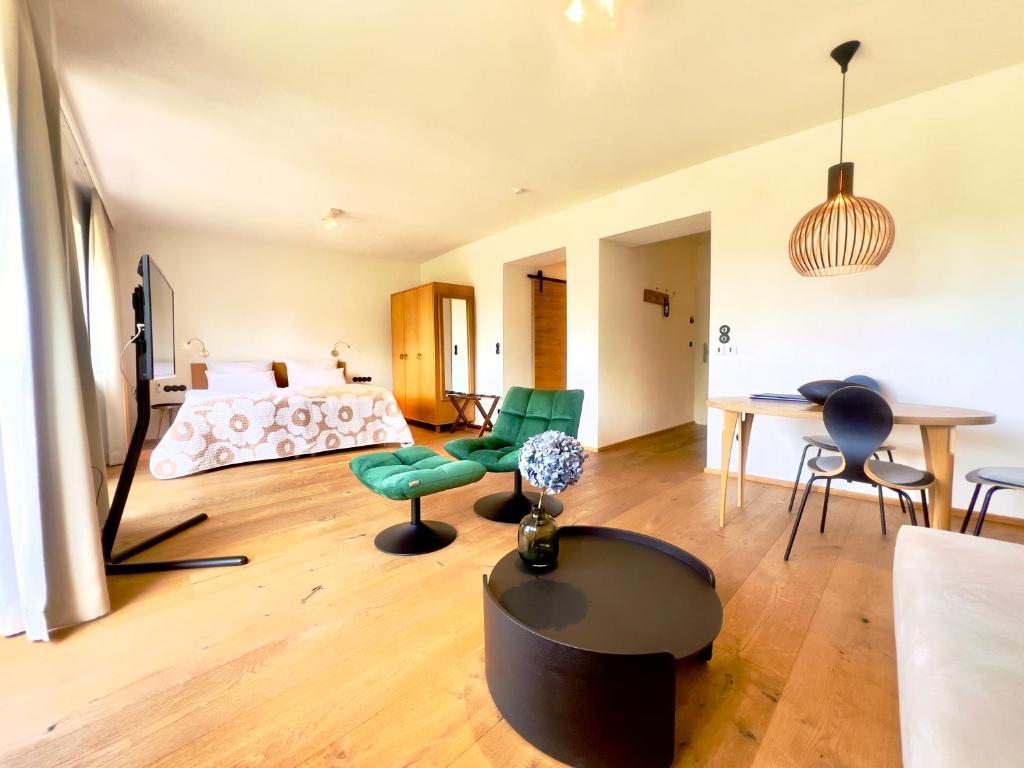 a bedroom with a bed and a table and chairs at Hotel Berghof in Seefeld in Tirol
