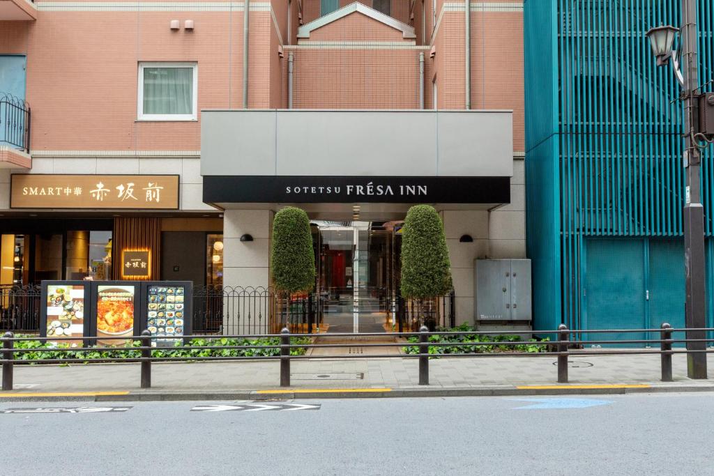 a building with a sign for a sushi fresh inn at Sotetsu Fresa Inn Tokyo-Akasaka in Tokyo