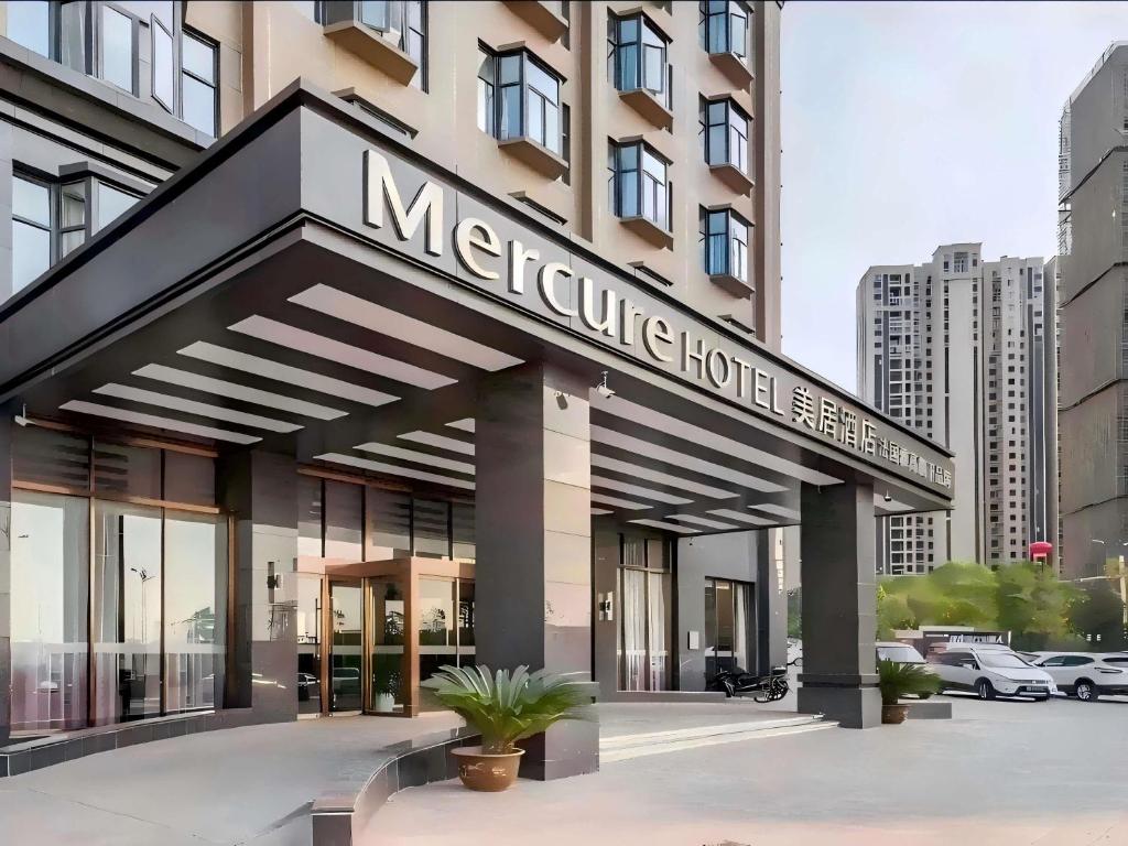 a large hotel building with a sign that reads metroline hotel at Mercure Wuhan Yangluo in Wuhan