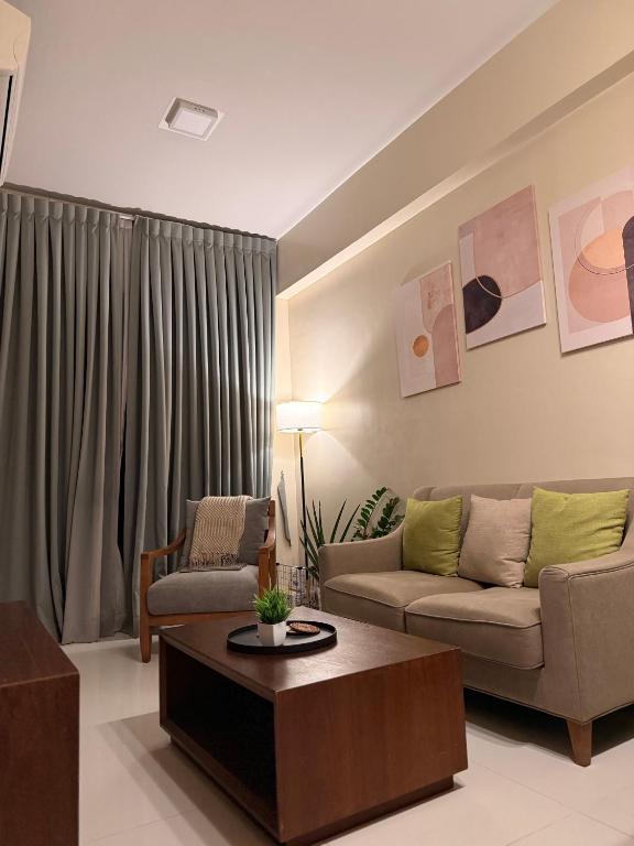a living room with a couch and a coffee table at Ocean View Escape at The Mactan Newtown in Punta Engaño