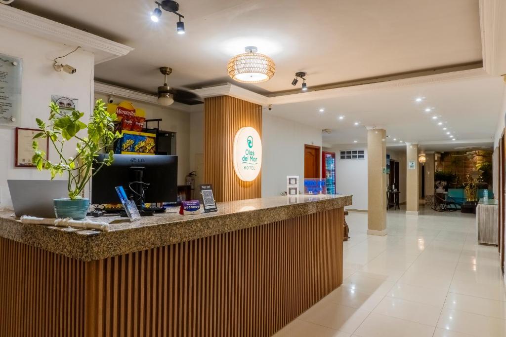 a lobby with a bar in a building at Olas del Mar Hotel by GHO Hoteles in Santa Marta