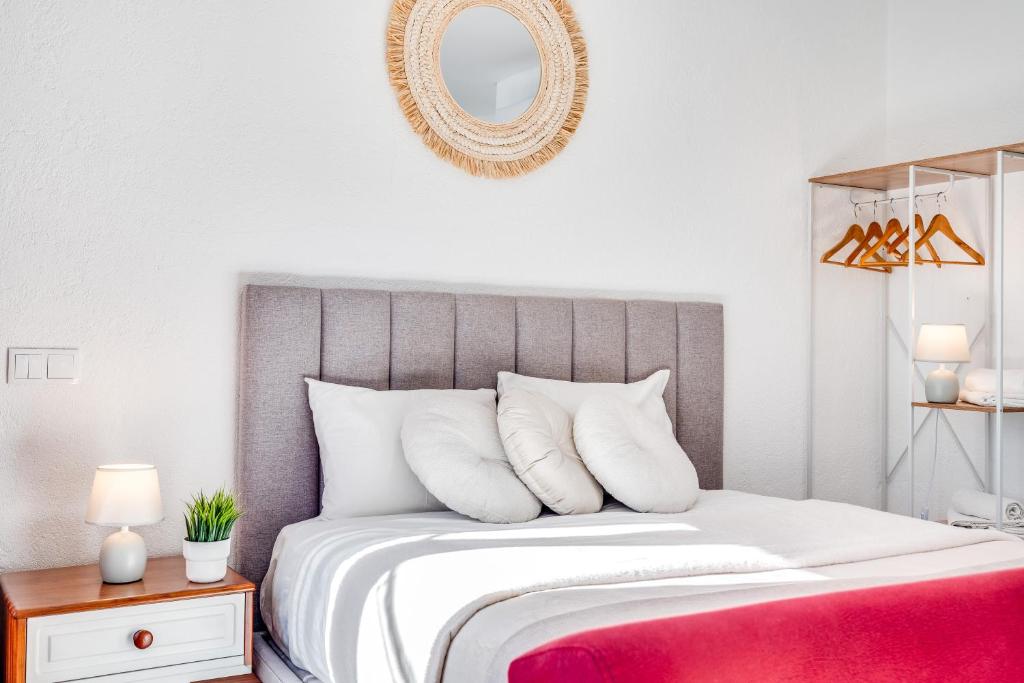 a bedroom with a large bed with a red blanket at Studio - Old Town Albufeira in Albufeira