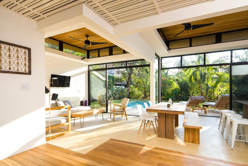 an open living room with a table and chairs at Nalu Nosara Pool Villa Sol in San Rafael