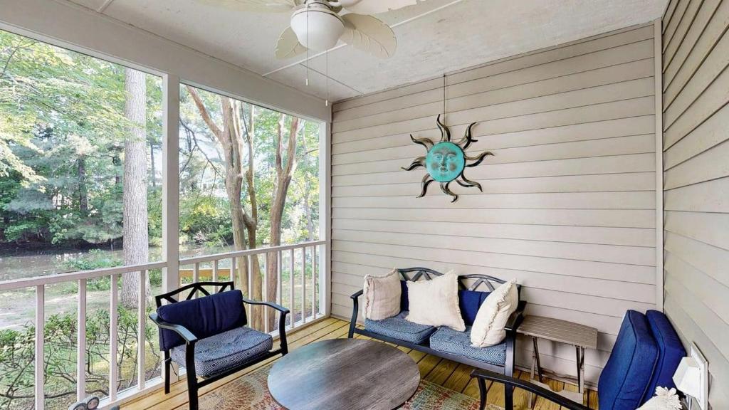 a screened in porch with two chairs and a table at Salt Pond --- 38435 Mainsail Dr #9 in Bethany Beach