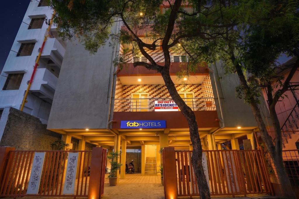 a building with a sign on the front of it at FabHotel Infinity Residency in Pune