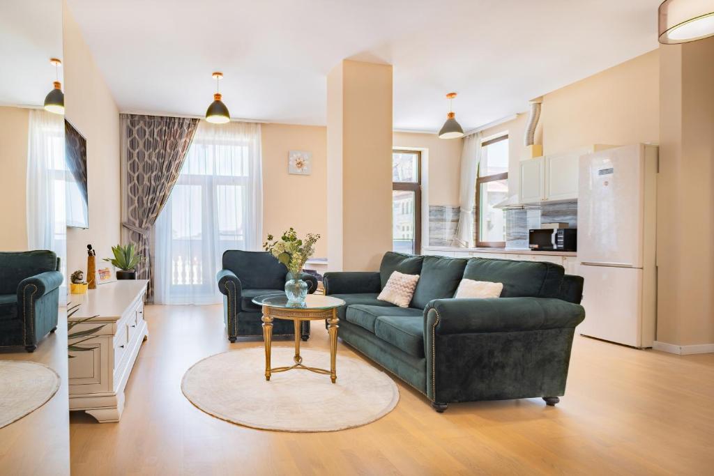 a living room with a couch and a table at Next Apartments Constanta in Constanţa