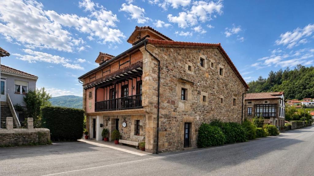an old stone building on the side of a road at Posadaochohermanas in Las Fraguas