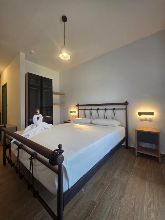 a bedroom with a large bed with white sheets at Falirala Central in Faliraki