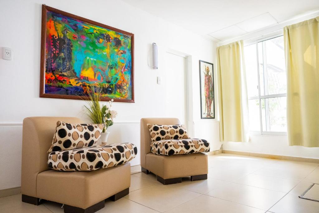 a living room with two chairs and a painting at HYGGE FORMOSA in Formosa