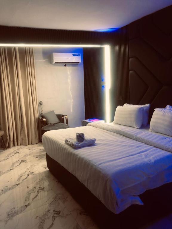 a hotel room with a large bed with a blue light at Kim Royal Hotel and Suites in Festac Town