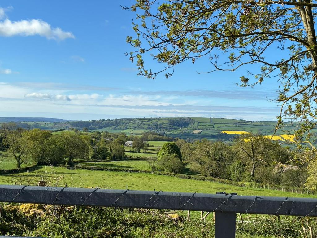 a view of a green field with a fence at Cefn Farm - Hyssington Heights in Hyssington