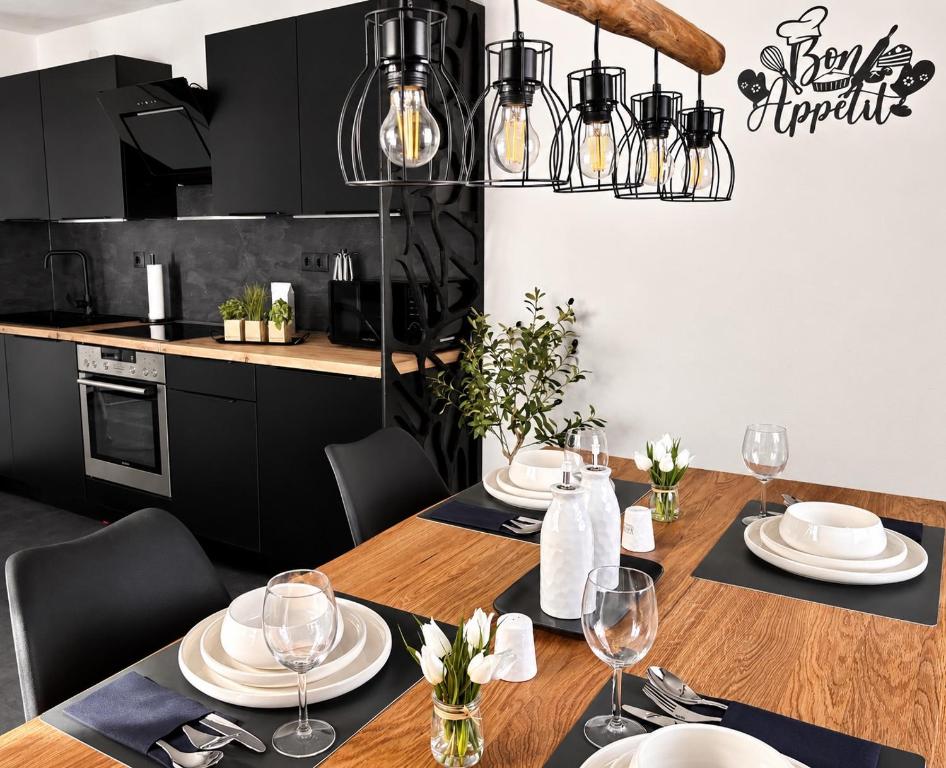 a dining room with a table with plates and wine glasses at Ferienhaus Schieferland in Müllenbach