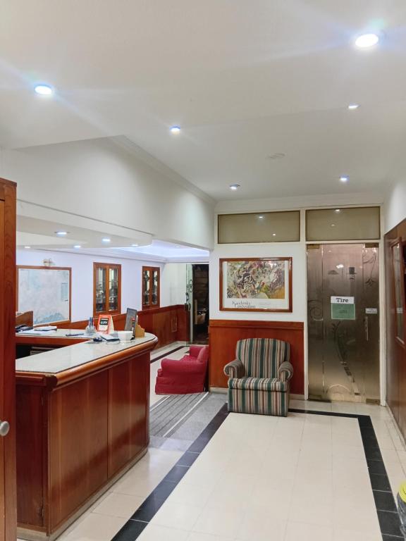 a large office with a desk and a chair at Hotel guido palace in Buenos Aires