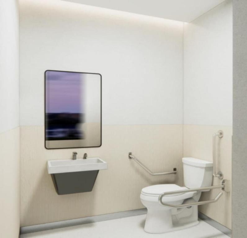 a bathroom with a toilet and a sink and a mirror at Sheena Apartment in Manila