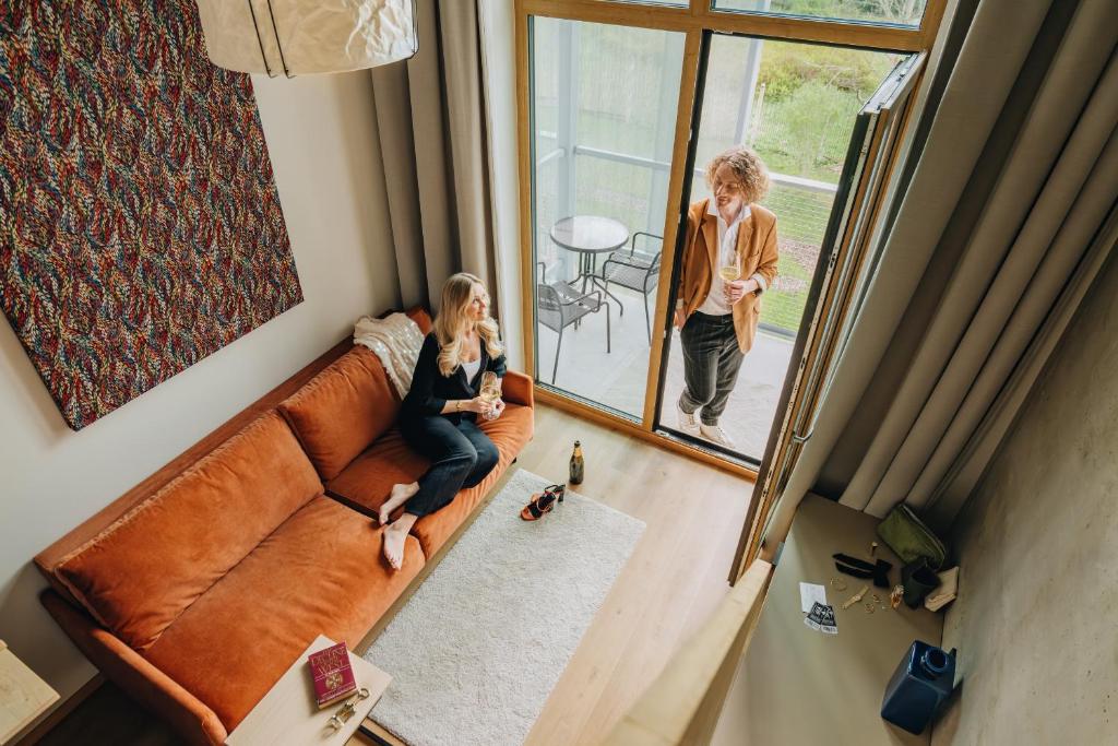 a young girl sitting on a couch in a living room at Sume by Larsen in Tallinn