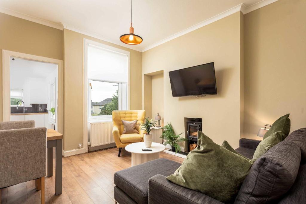 a living room with a couch and a chair at Scott Suite - Donnini Apartments in Kilmarnock