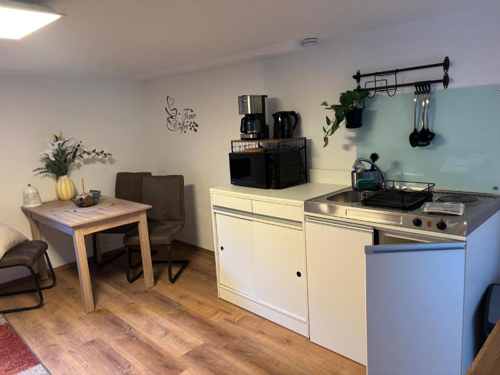a kitchen with a stove and a table in a room at Small 45 M² Apartment in Bad Kreuznach