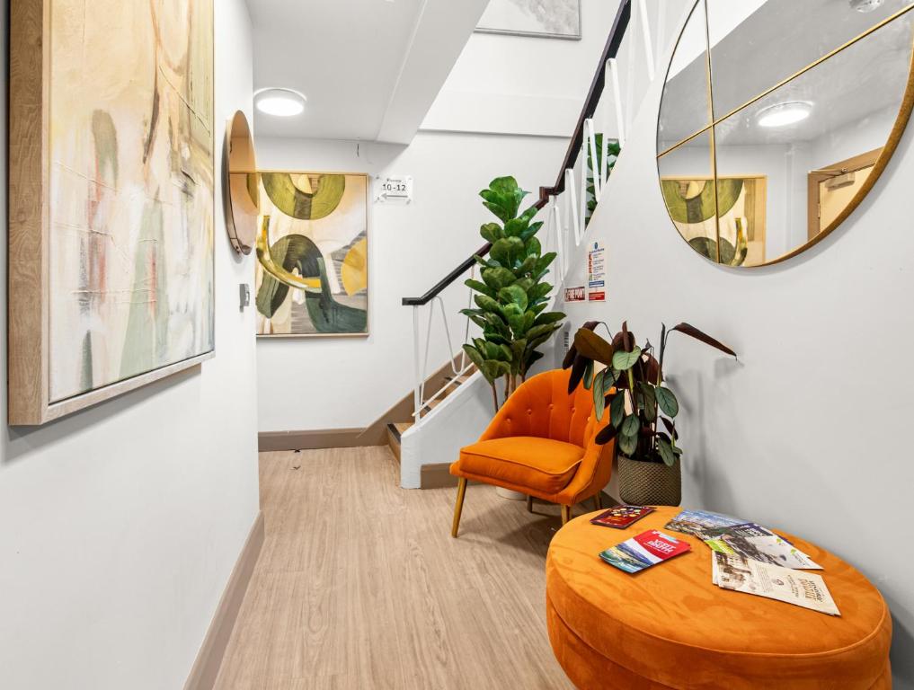 an orange chair and a table in a room at Clanbrassil Townhouse in Dundalk