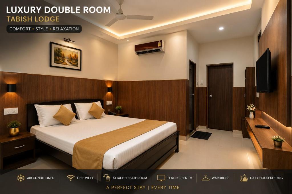 a hotel room with a bed and a television at Tabish INN in Trivandrum