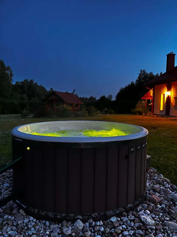 a large hot tub in a yard at night at D&A Vila - Private Villa with Sauna & Hot Tub in Arciūnai
