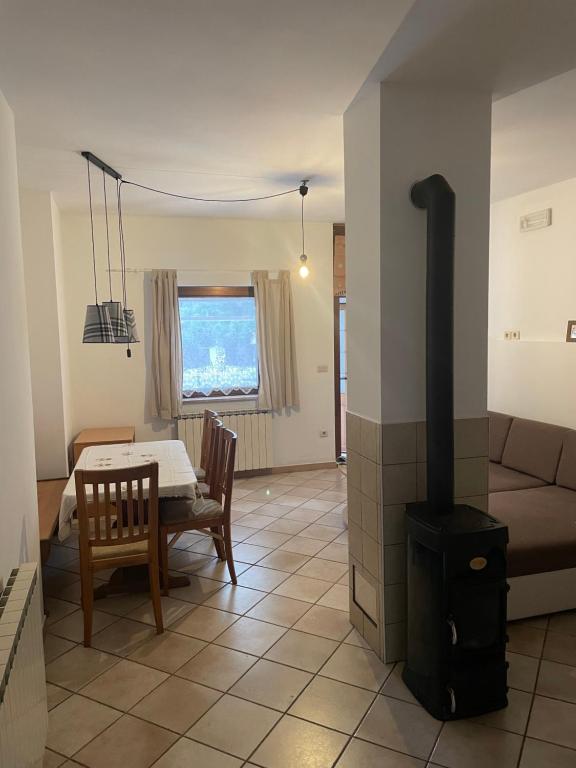 a living room with a wood stove and a table at Soča Kayaker in Čezsoča