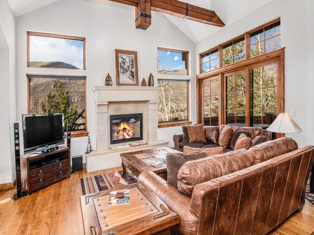 a living room with a couch and a fireplace at Alpine Drive Chalet in Vail