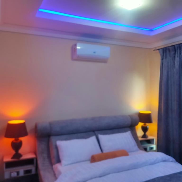 a bedroom with a bed with a blue light above it at Exclusive guest house in Modimolle
