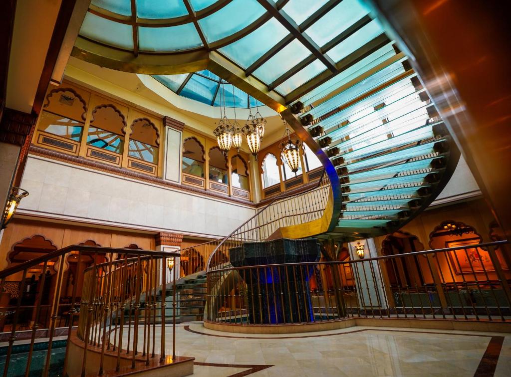 a spiral staircase in a building with a glass ceiling at Avari Lahore Hotel in Lahore